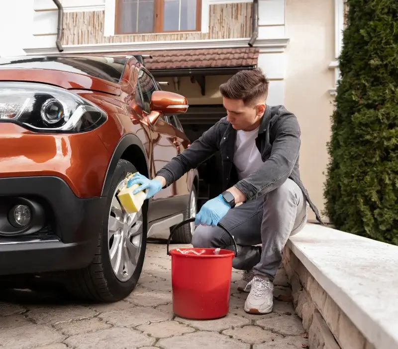 Lavage auto à domicile Ambernac : professionnel intervenant sur un véhicule